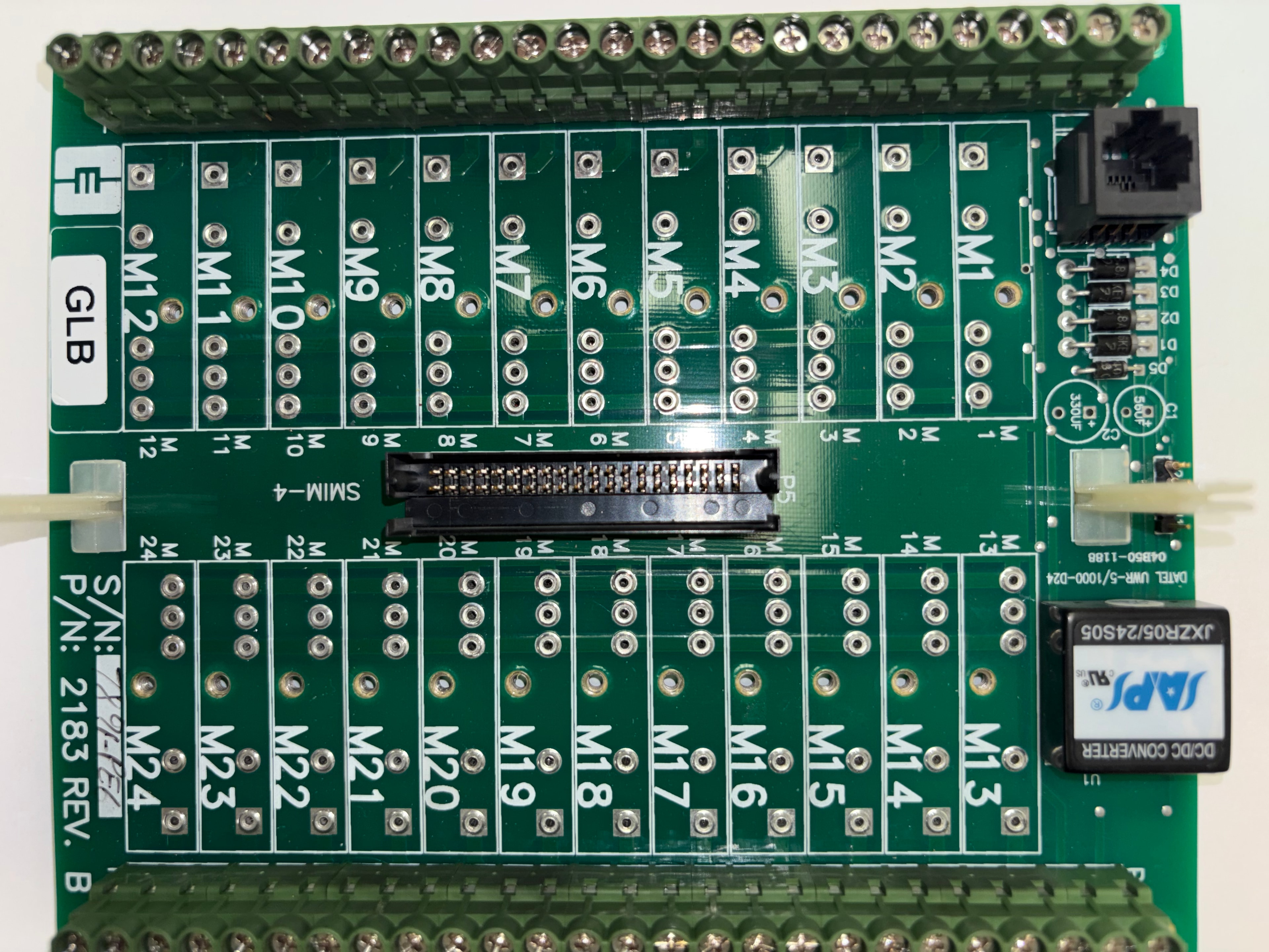 CEC P/N 2183 Rev B GLB motor interface terminal board — M1–M24 terminal groups, SMIM-4 connector, SAPS JXZR05/24S05, DATEL UWR-5/1000-D24, green screw terminal blocks top and bottom