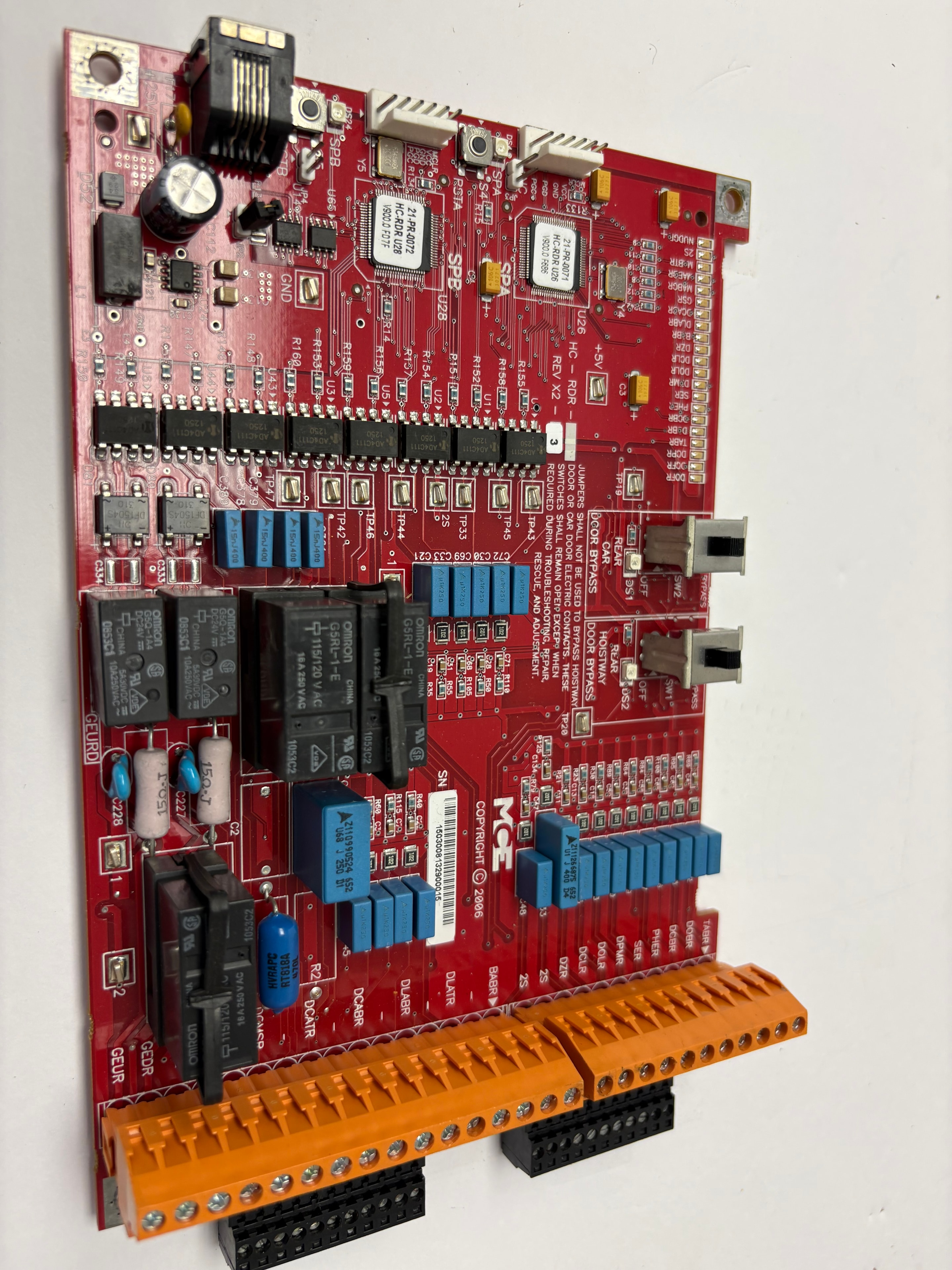 MCE Engineering HC-RDR elevator door control board — red PCB with blue relays, Omron G5RL-1-E relays, orange terminal blocks, REV X2–3